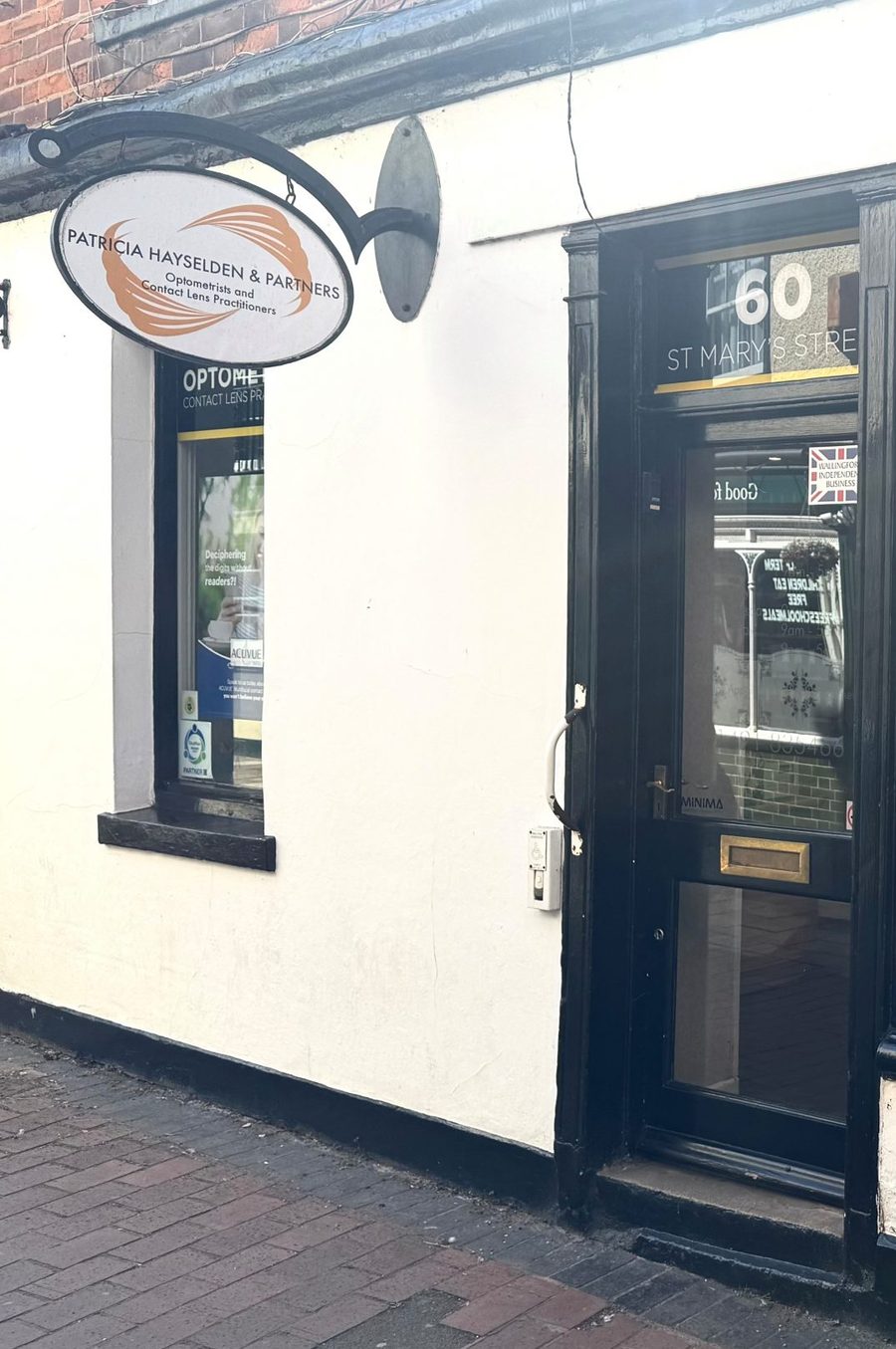 The oval sign and the black door, a few doors off the Market Place.
